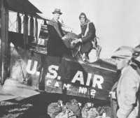 Charles Lindbergh loads the first sack of mail